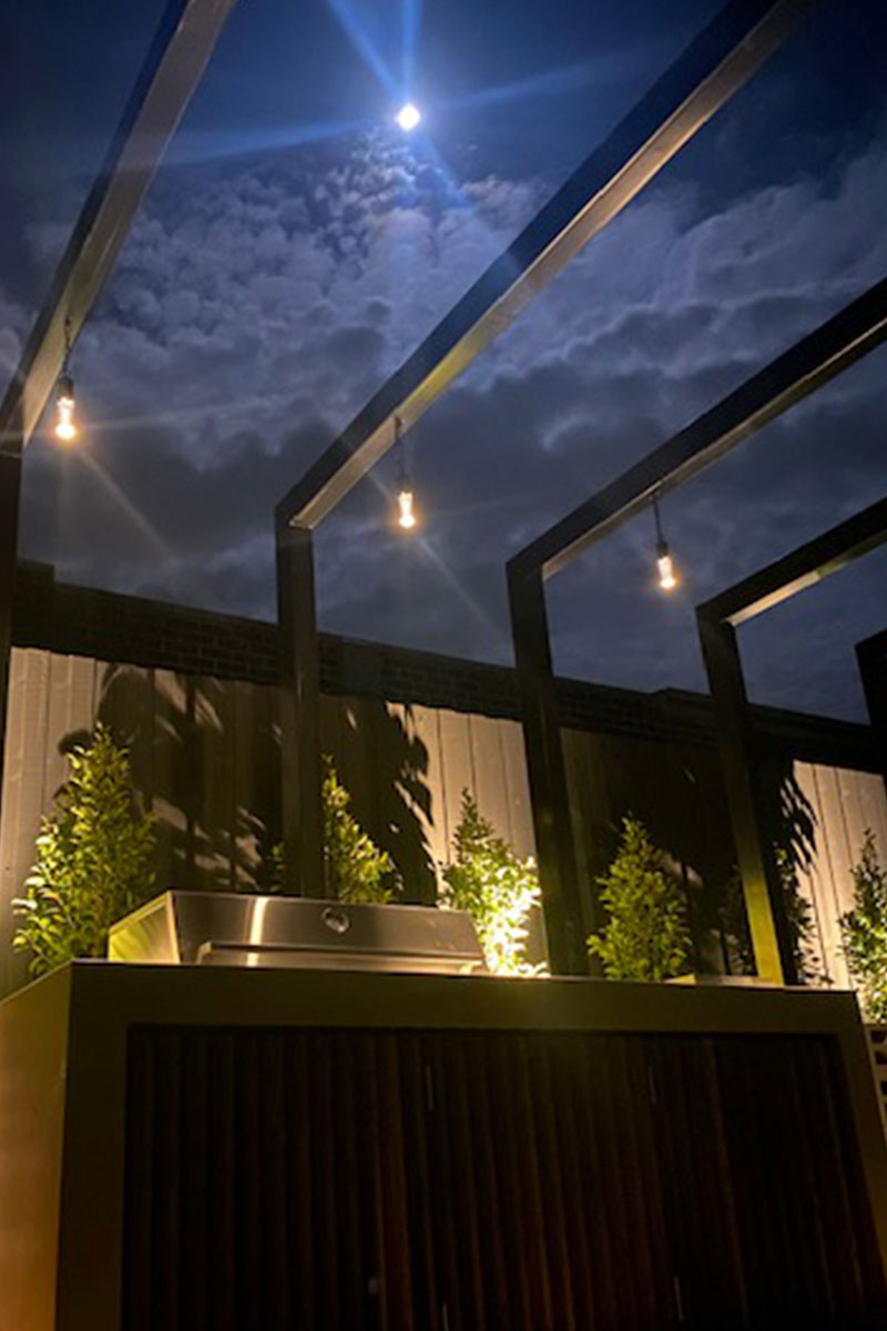 bbq area lighting hanging light from gardens at night
