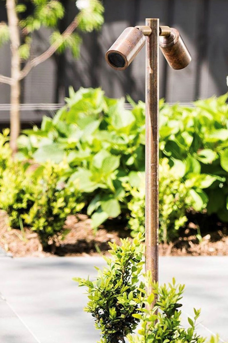 Gardens at Night adjustable twin pole light in copper finish in garden