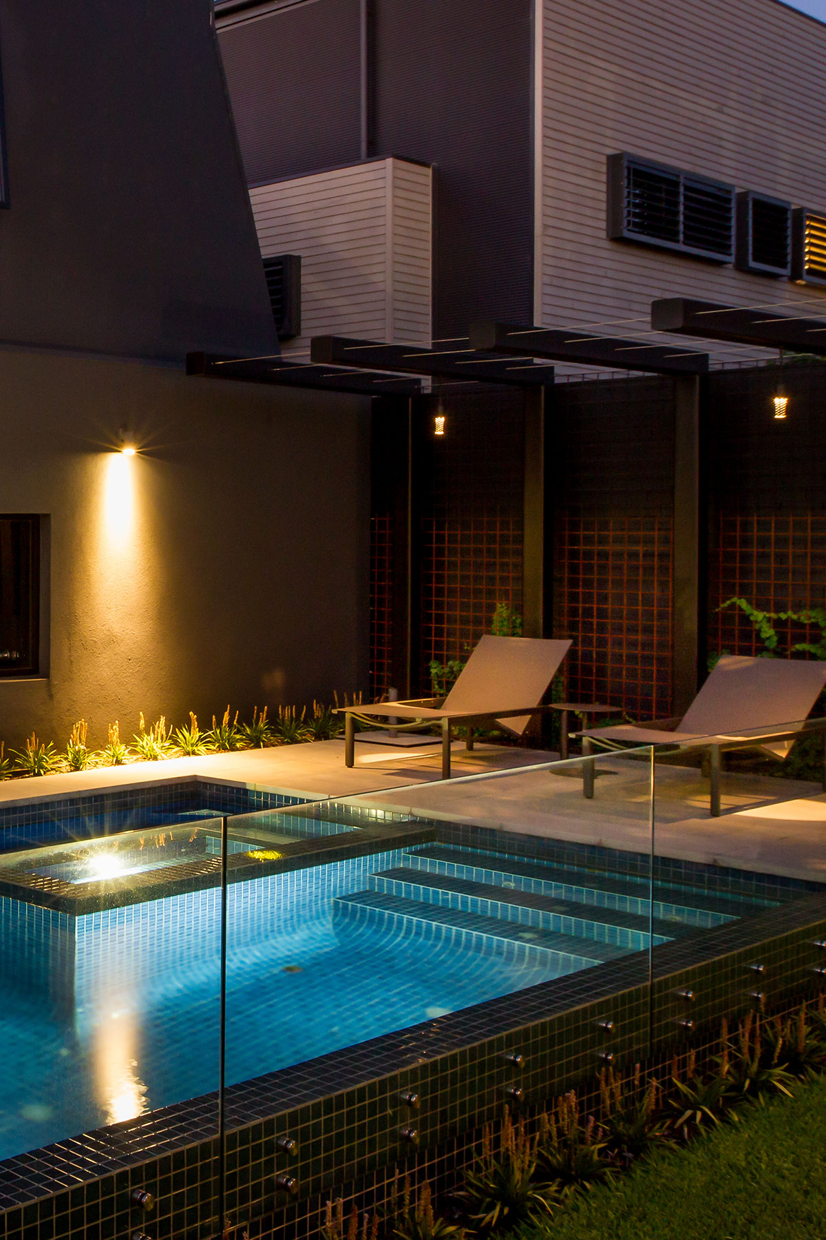 Gardens at Night Hanging Light Speckle overhead light in landscaped area by pool