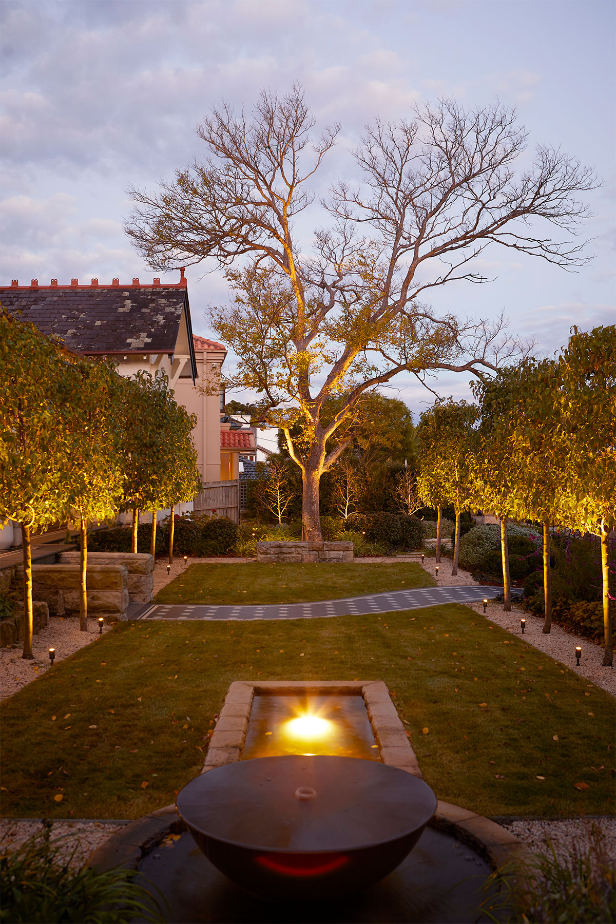 Gardens at Night underwater light illuminating water feature in landscaped garden sydney australia in