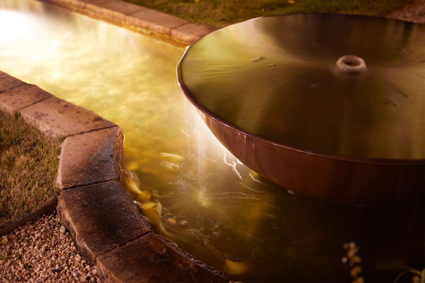 Gardens at Night underwater light in landscaped water feature and garden by Inspired Exteriors